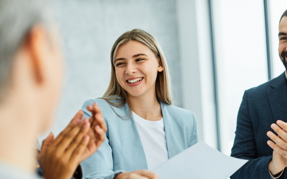 Gen Z employee applauded by colleagues