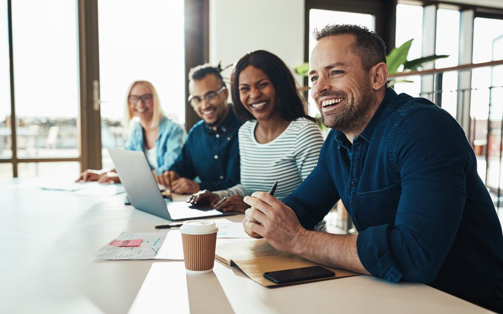 HR professionals and decision makers having a laugh at a meeting
